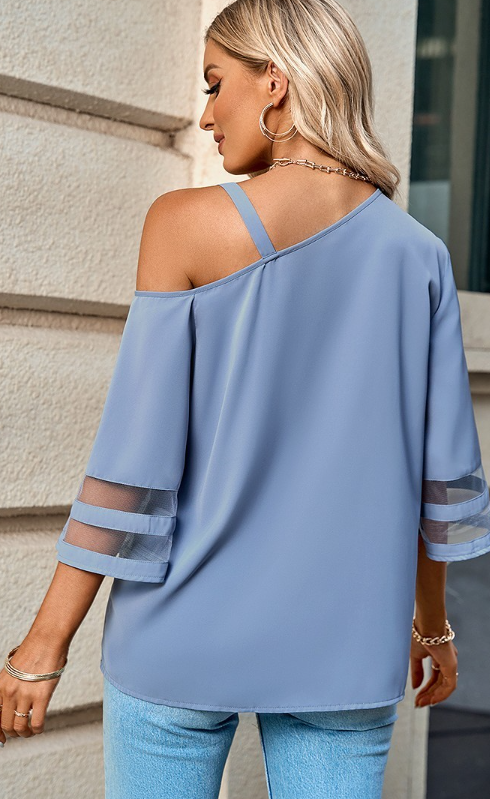 Elegant and simple asymmetrical blouse with golden buckle.